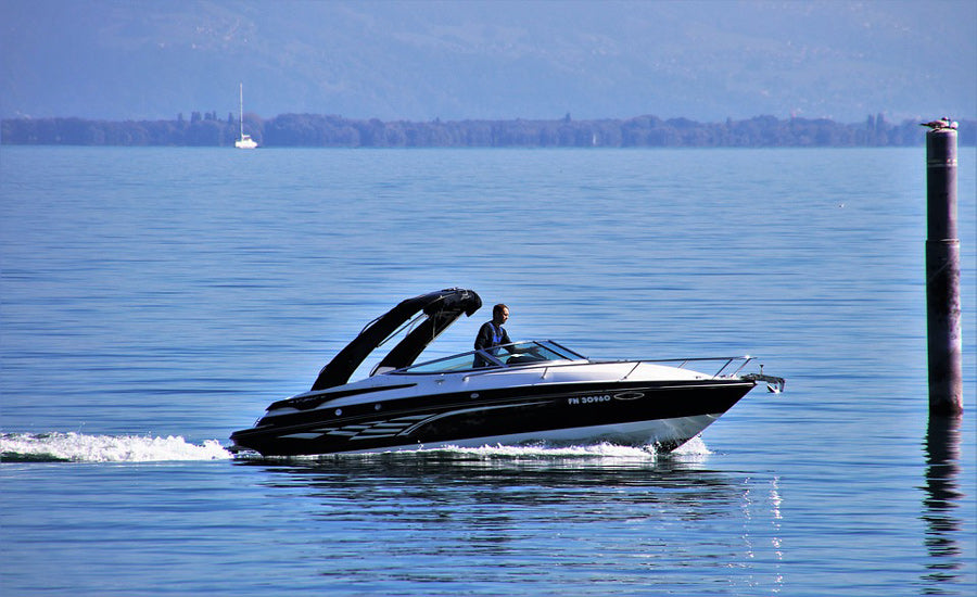Man operating motorboat on a lake