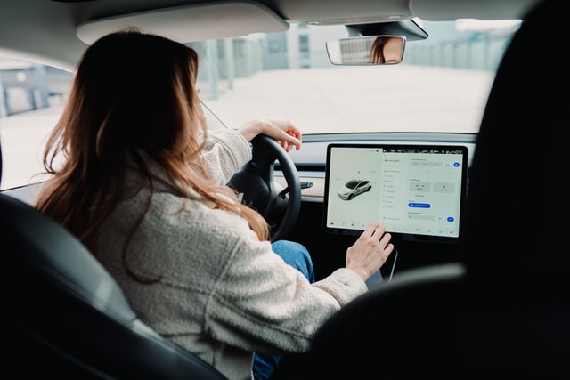 Woman using a tablet in her vehicle